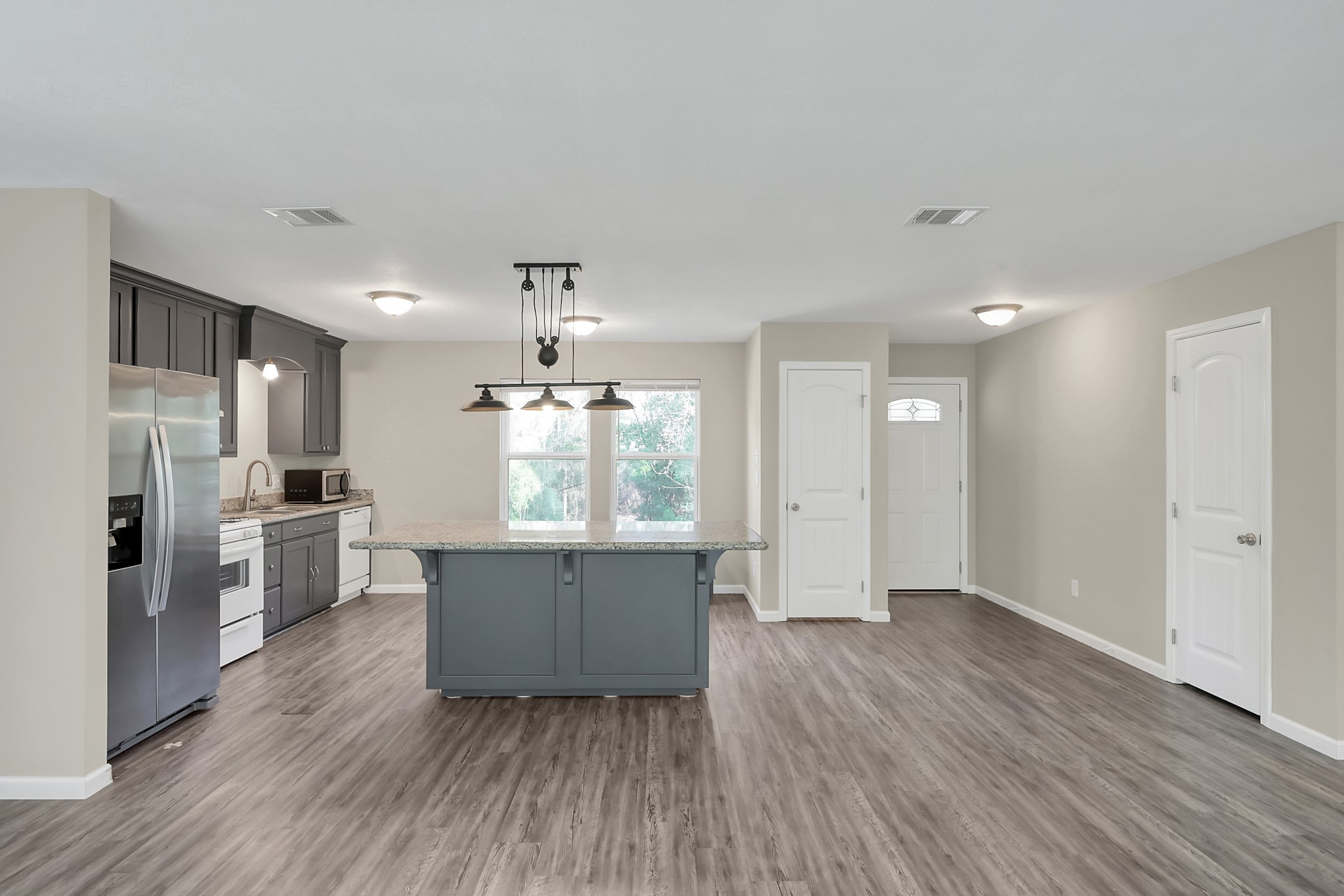 3527 Gary Lane Spring, TX 77380 - Photo 7 of 47 a large kitchen with a wooden floor and stainless steel appliances