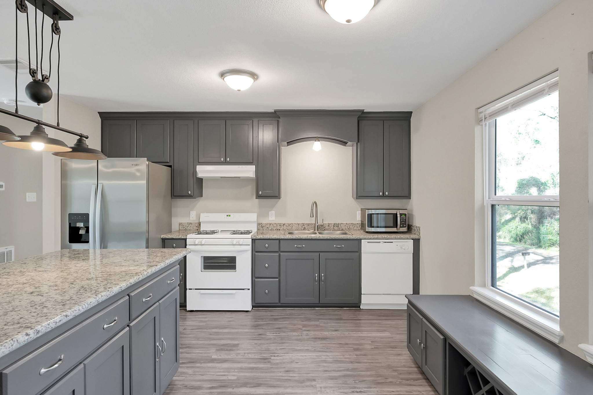 3527 Gary Lane Spring, TX 77380 - Photo 10 of 47 a kitchen with stainless steel appliances granite countertop a stove a sink dishwasher a refrigerator and white cabinets with wooden floor