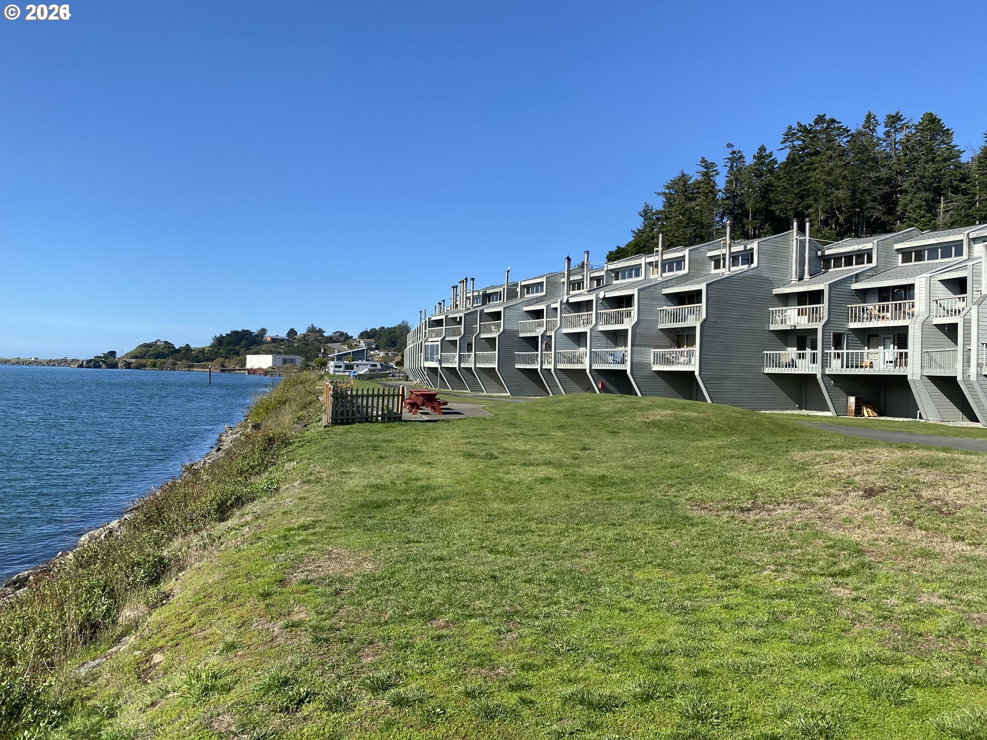 94304 Wedderburn Loop, Unit 419 Gold Beach, OR 97444 - Photo 18 of 23 a large body of water with a building in the background