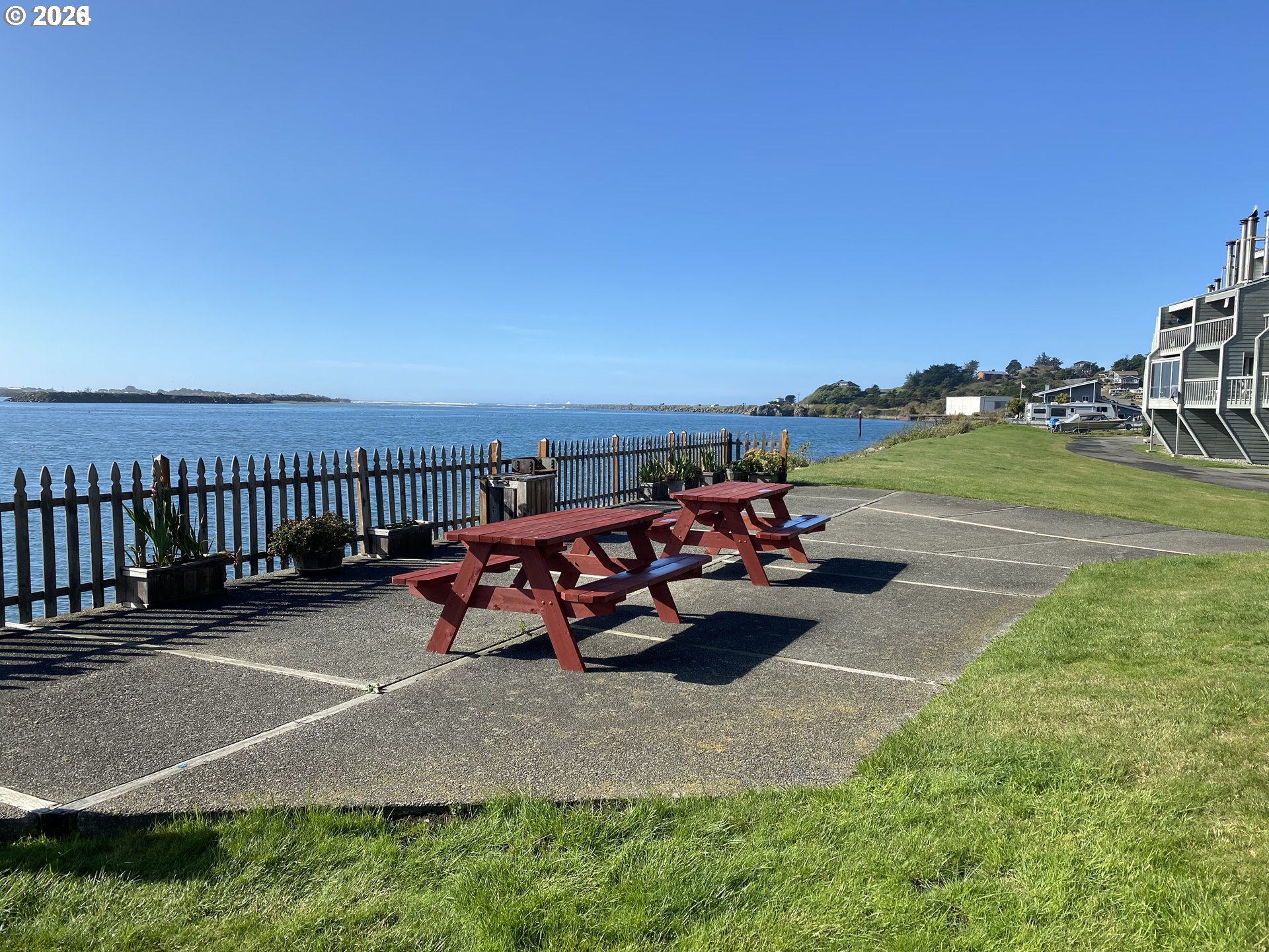 94304 Wedderburn Loop, Unit 419 Gold Beach, OR 97444 - Photo 19 of 23 a view of a patio with table and chairs