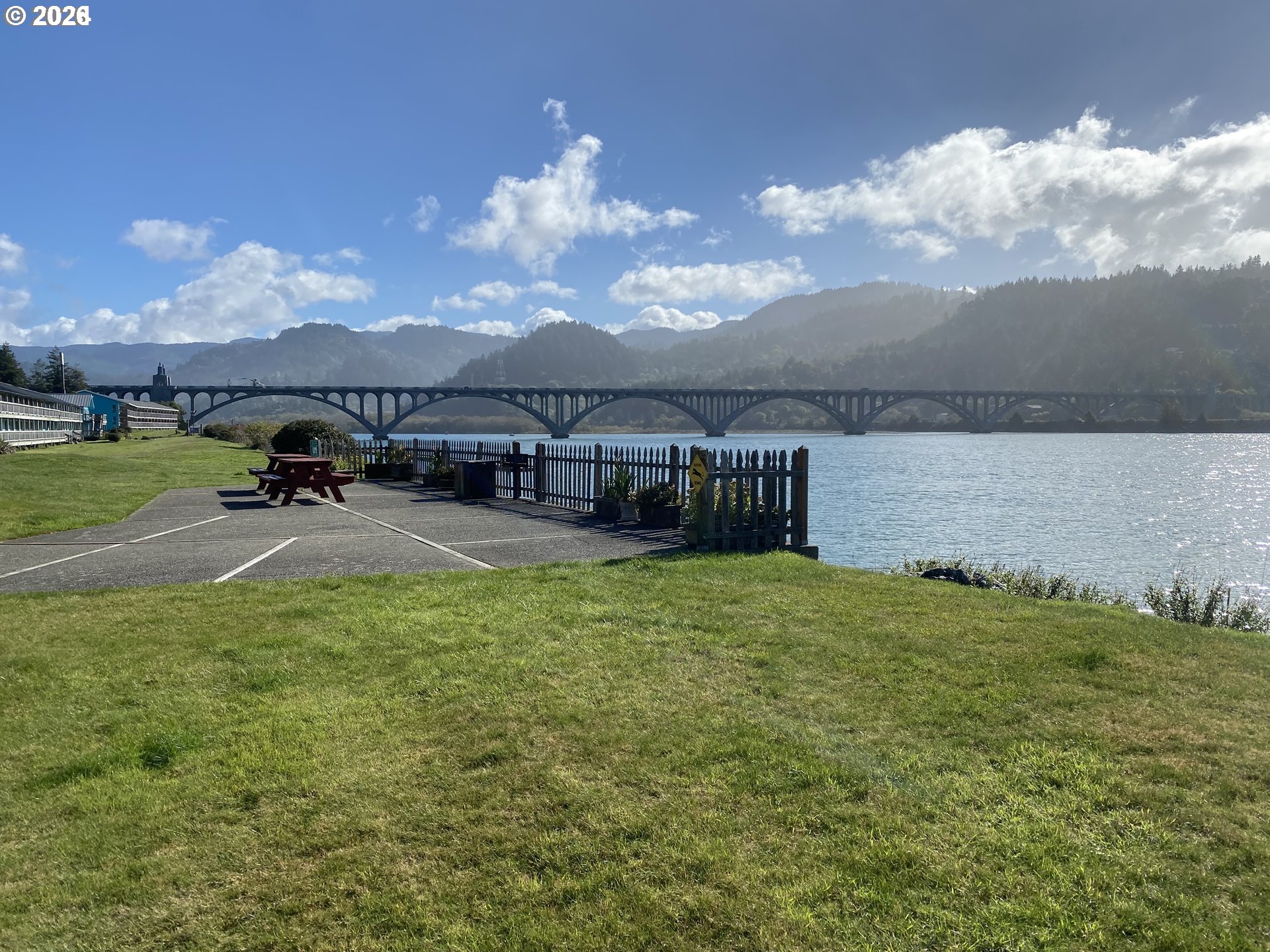 94304 Wedderburn Loop, Unit 419 Gold Beach, OR 97444 - Photo 21 of 23 a terrace with outdoor seating and lake