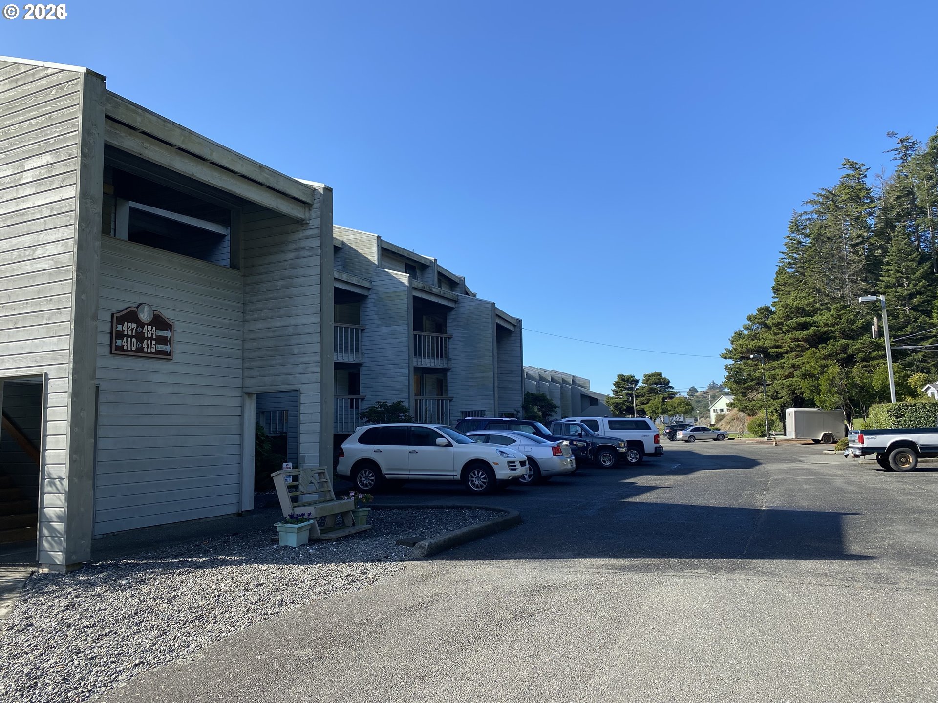 94304 Wedderburn Loop, Unit 419 Gold Beach, OR 97444 - Photo 23 of 23 a cars parked in front of a house