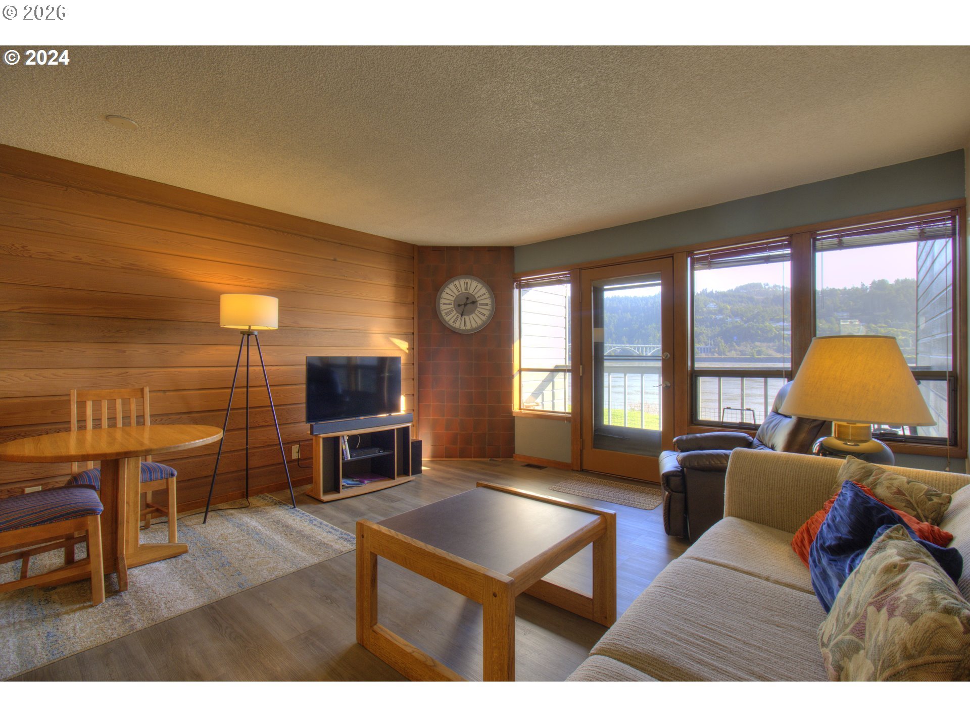 94304 Wedderburn Loop, Unit 419 Gold Beach, OR 97444 - Photo 3 of 23 a living room with furniture and a flat screen tv