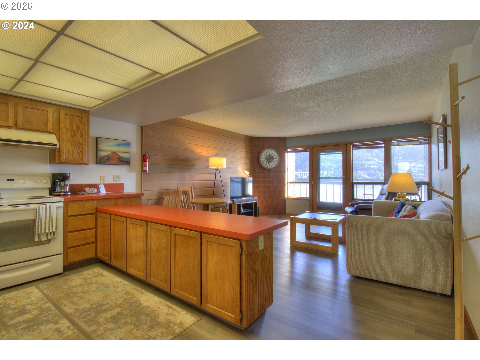 94304 Wedderburn Loop, Unit 419 Gold Beach, OR 97444 - Photo 6 of 23 a open kitchen with cabinets a sink and a stove