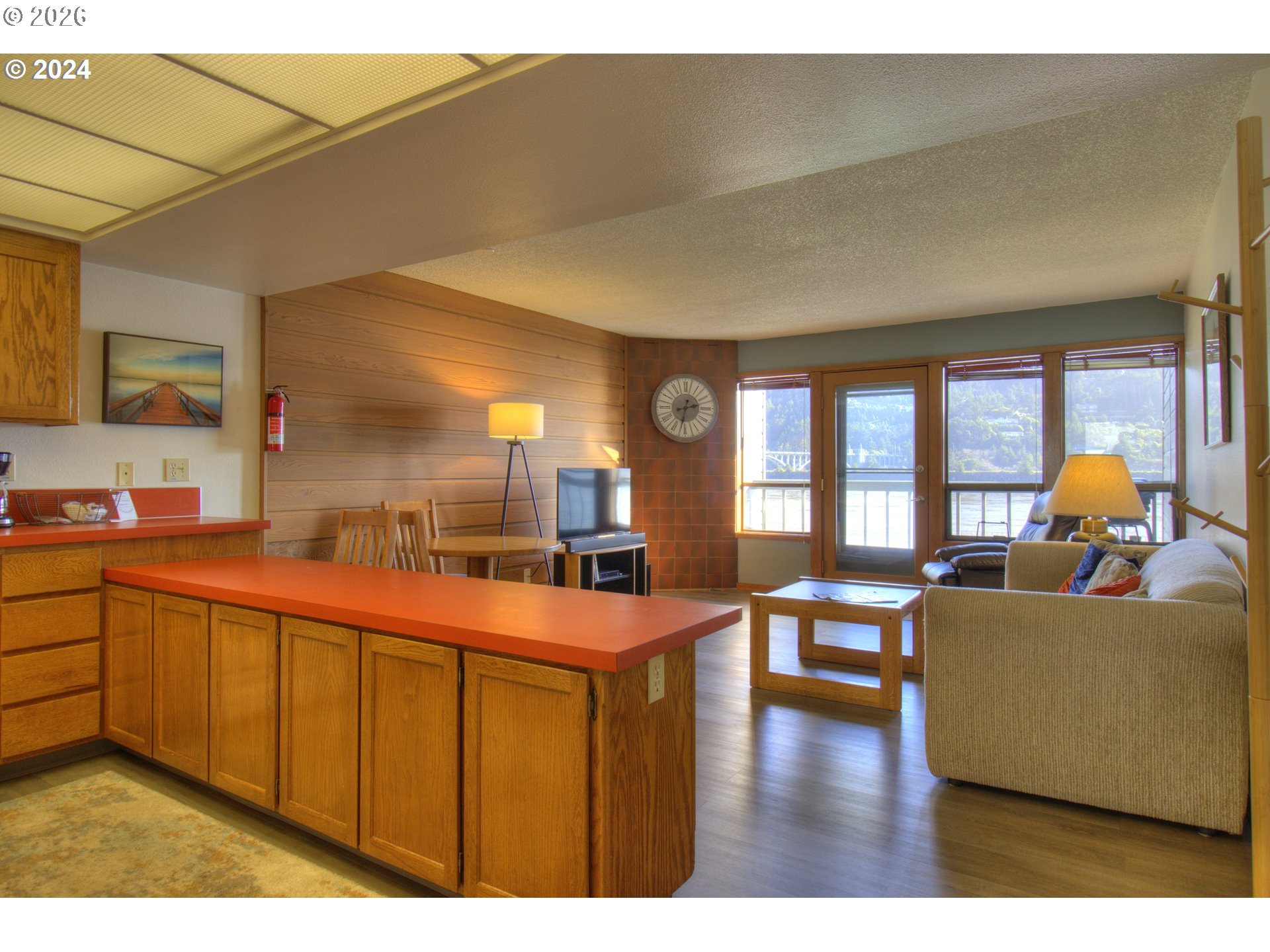 94304 Wedderburn Loop, Unit 419 Gold Beach, OR 97444 - Photo 7 of 23 a living room with stainless steel appliances furniture and a large window