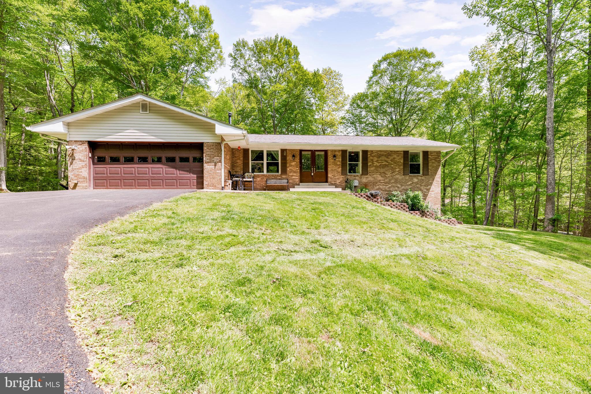 1641 Colonial Oak Court Huntingtown, MD 20639 - Photo 1 of 1 a front view of a house with a garden