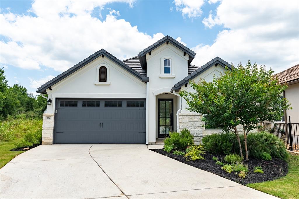 a view of house with a yard and potted plants