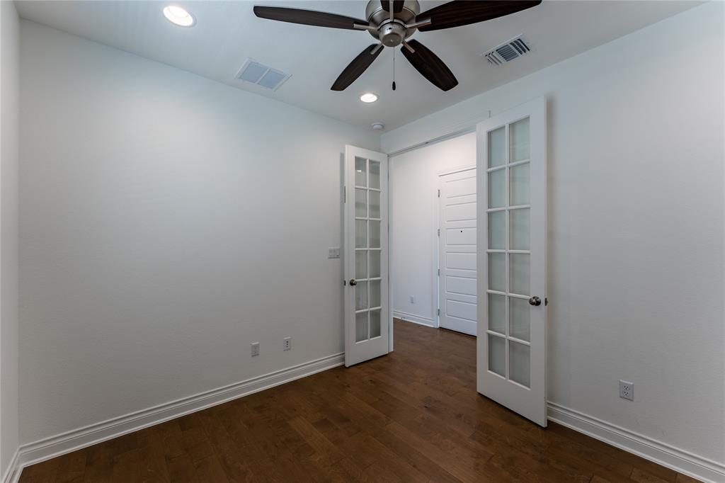 152 Limestone Drive Georgetown, TX 78628 - Photo 11 of 36 an empty room with wooden floor closet fan and windows