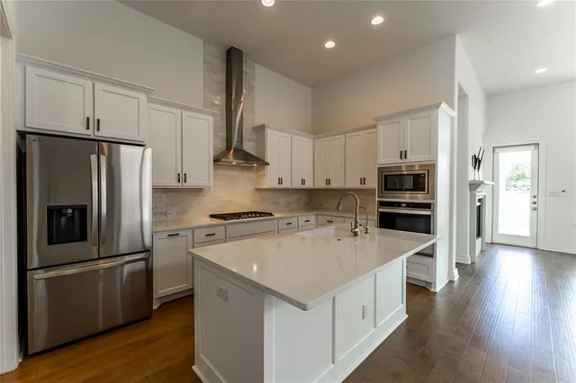 a kitchen with stainless steel appliances a refrigerator sink and cabinets