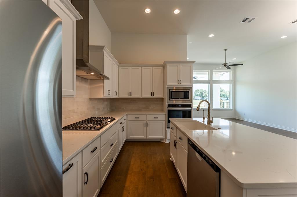 152 Limestone Drive Georgetown, TX 78628 - Photo 16 of 36 a kitchen with stainless steel appliances granite countertop a sink stove and refrigerator
