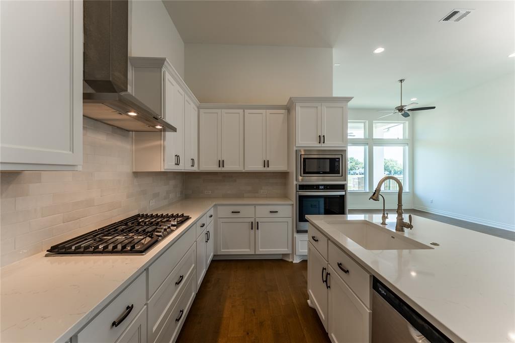 152 Limestone Drive Georgetown, TX 78628 - Photo 17 of 36 a kitchen with a sink stove and refrigerator