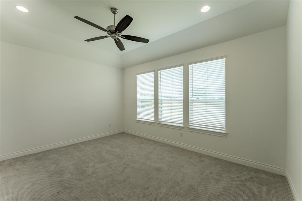 152 Limestone Drive Georgetown, TX 78628 - Photo 22 of 36 an empty room with ceiling fan and windows