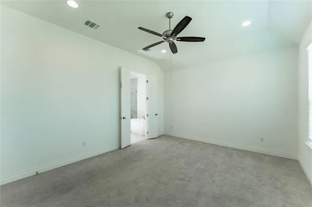 a view of a livingroom with a ceiling fan and entryway