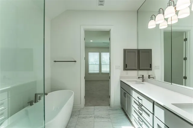 a bathroom with a double vanity sink mirror and shower