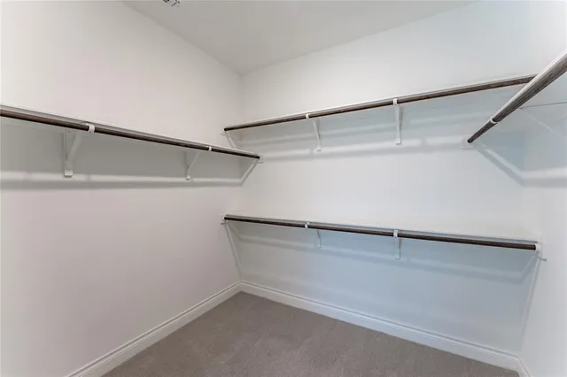 a bathroom with a double vanity sink a toilet a mirror and bathtub