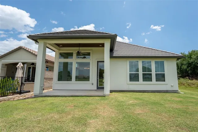 a view of an empty room with wooden floor fireplace and a window