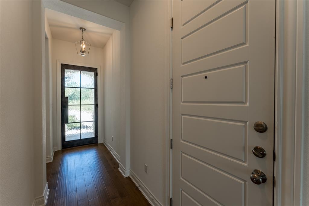 152 Limestone Drive Georgetown, TX 78628 - Photo 6 of 36 a view of a hallway with wooden floor