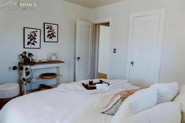 a bedroom with a bed and a chandelier