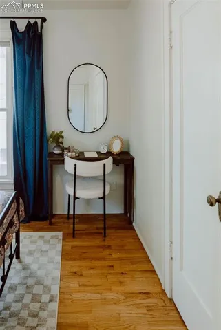 a living room with wooden floor furniture and a wooden floor