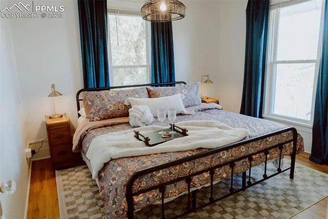 a bedroom with a bed and a chandelier