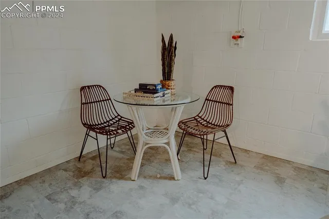 a view of a room with a table and chairs