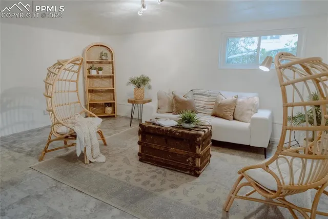 a living room with furniture a rug and a chandelier