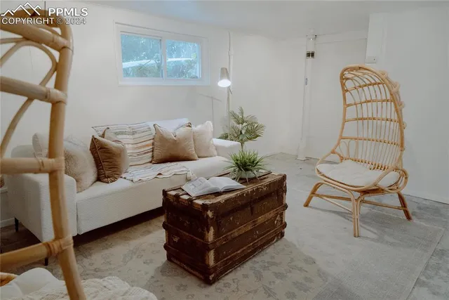 a living room with furniture flowerpot and a window