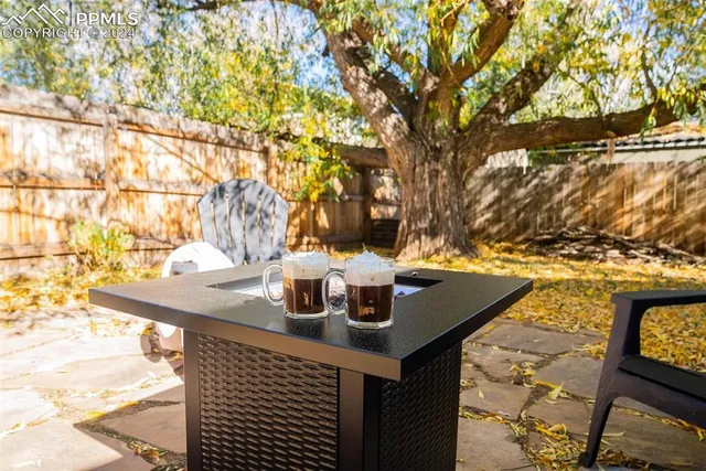 a view of table and chair and couches in the back yard