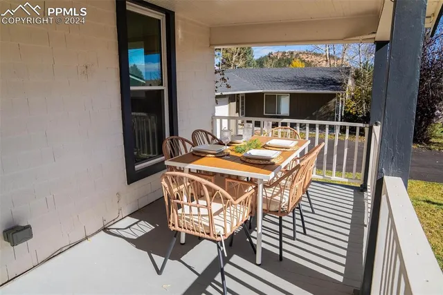 a view of a chairs and table in the balcony
