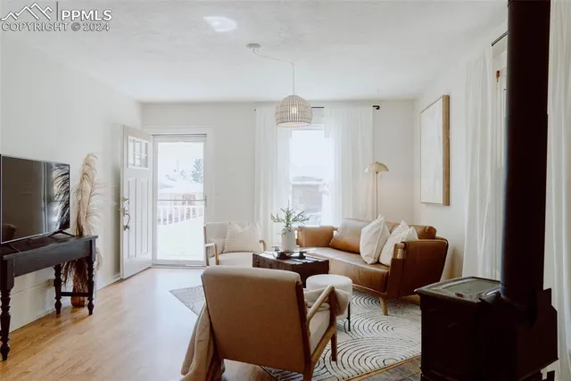 a living room with furniture a ceiling fan and a window