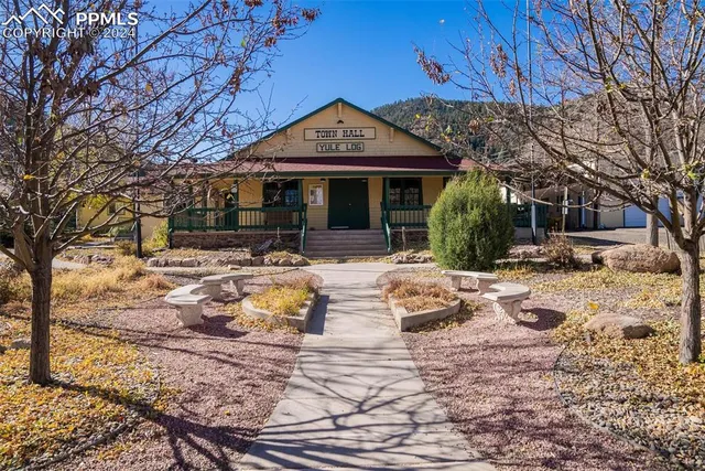 a front view of a building with of trees