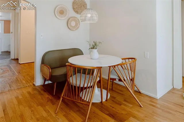 a dining room with furniture and wooden floor