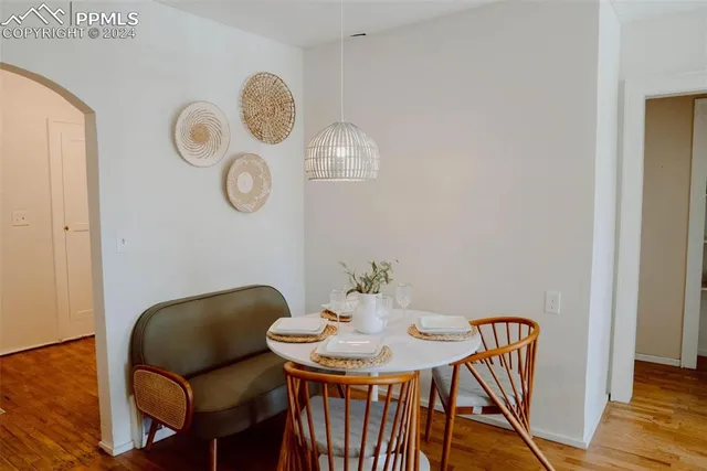 a view of a dining room with furniture and wooden floor