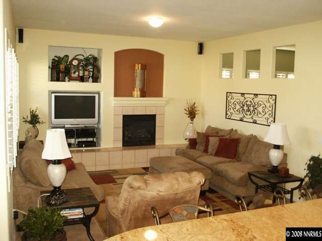 10620 Sterling Ridge Way Reno, NV 89521 - Photo 3 of 6 a living room with furniture a fireplace and a flat screen tv