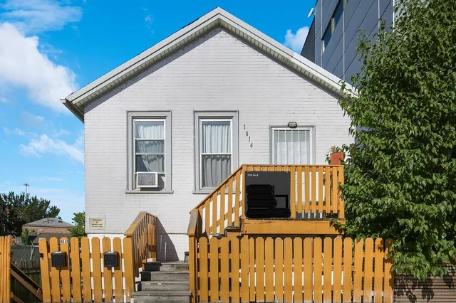 a view of a house with wooden fence