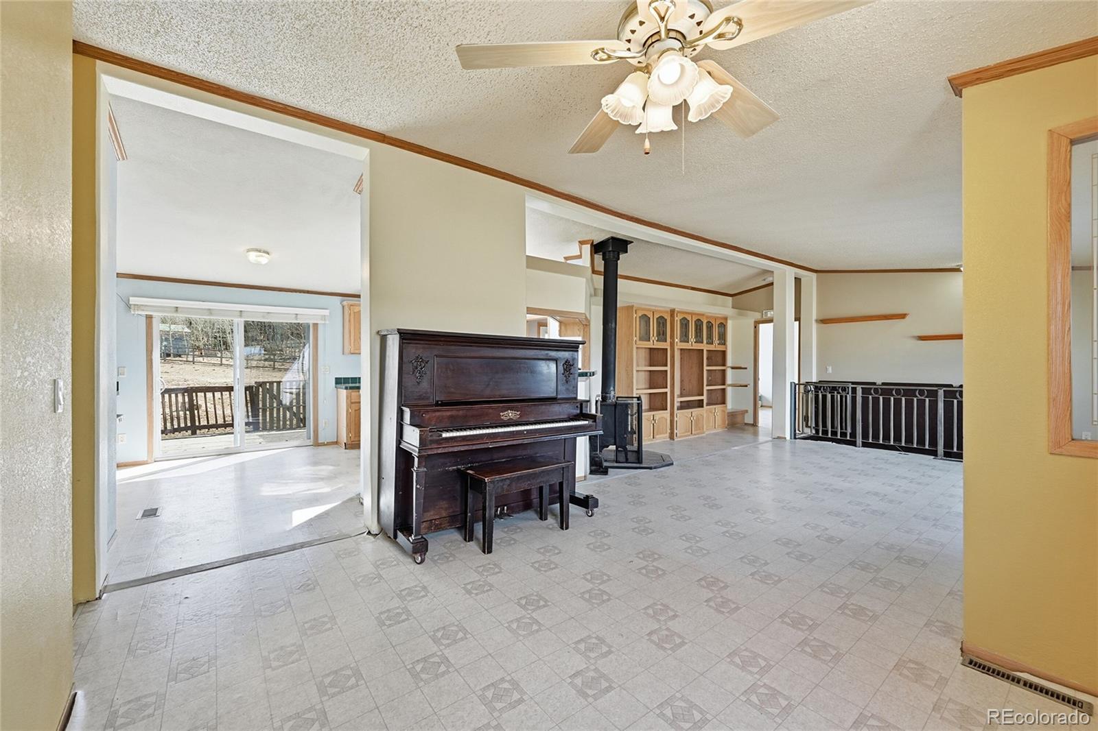 4441 Goldenburg Canyon Road Hartsel, CO 80449 - Photo 12 of 48 a living room with furniture and a flat screen tv