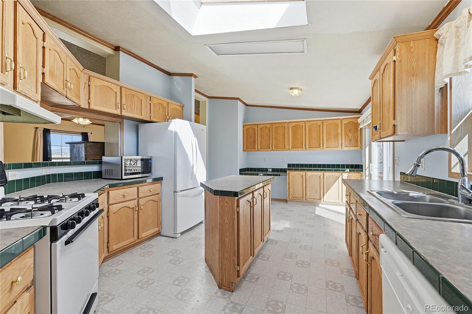 4441 Goldenburg Canyon Road Hartsel, CO 80449 - Photo 17 of 48 a kitchen with stainless steel appliances granite countertop a sink stove and refrigerator