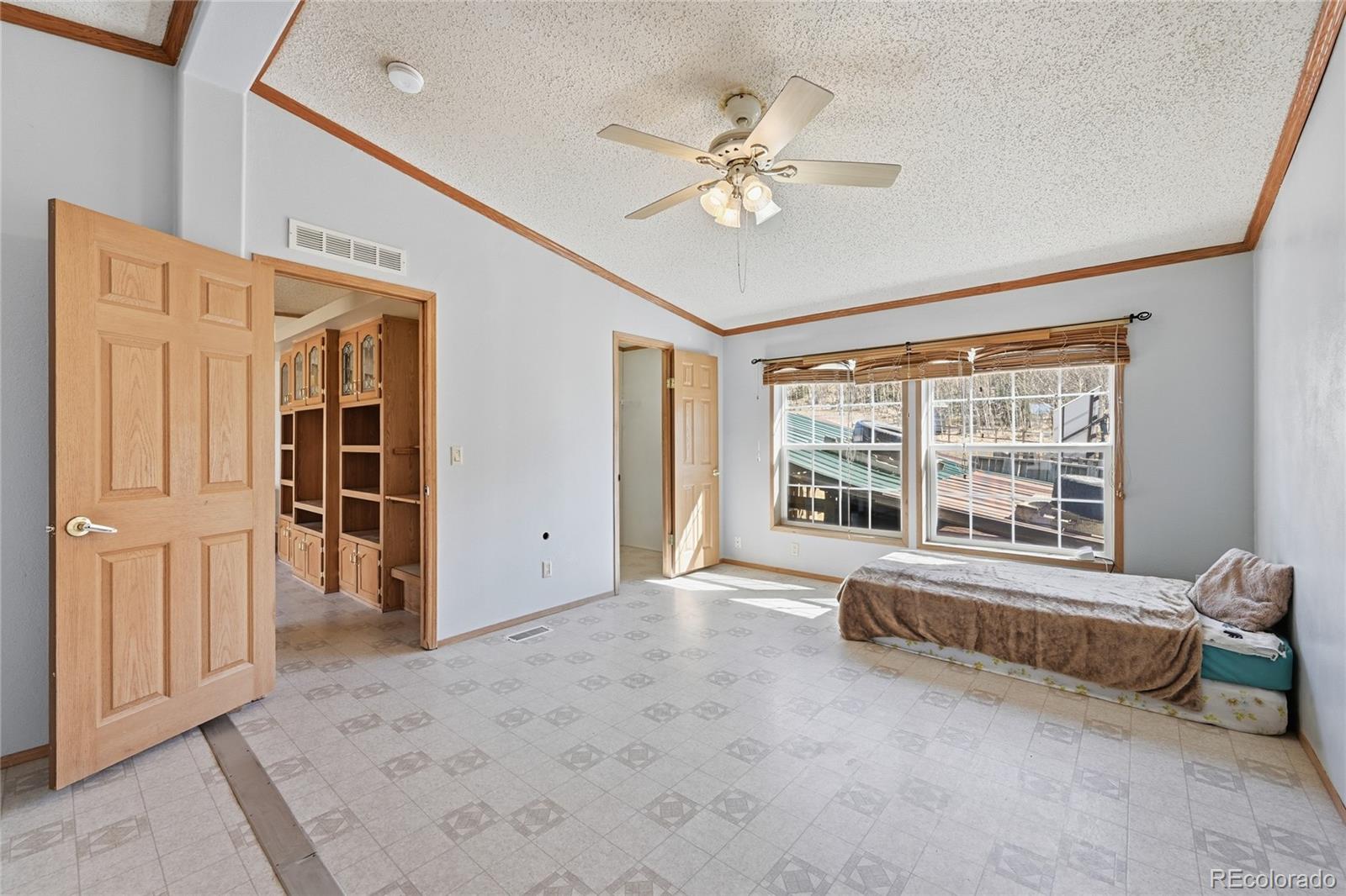 4441 Goldenburg Canyon Road Hartsel, CO 80449 - Photo 20 of 48 a spacious bedroom with a bed and a large window