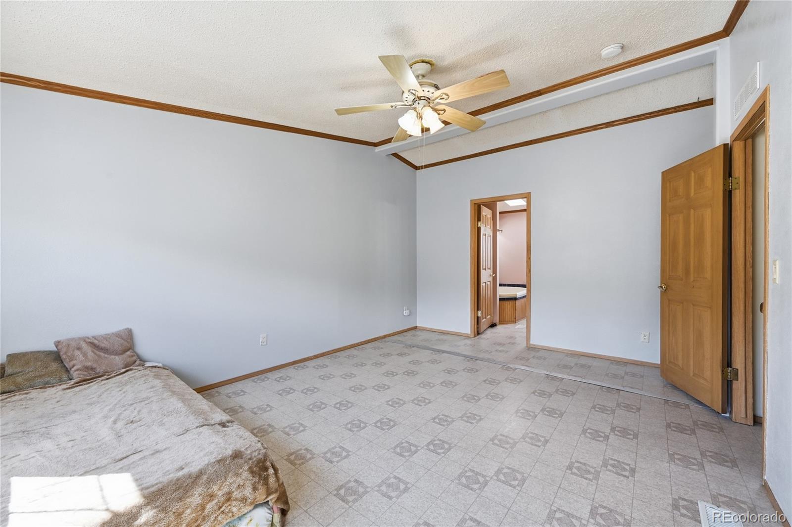 4441 Goldenburg Canyon Road Hartsel, CO 80449 - Photo 21 of 48 a bedroom with a bed and a chandelier