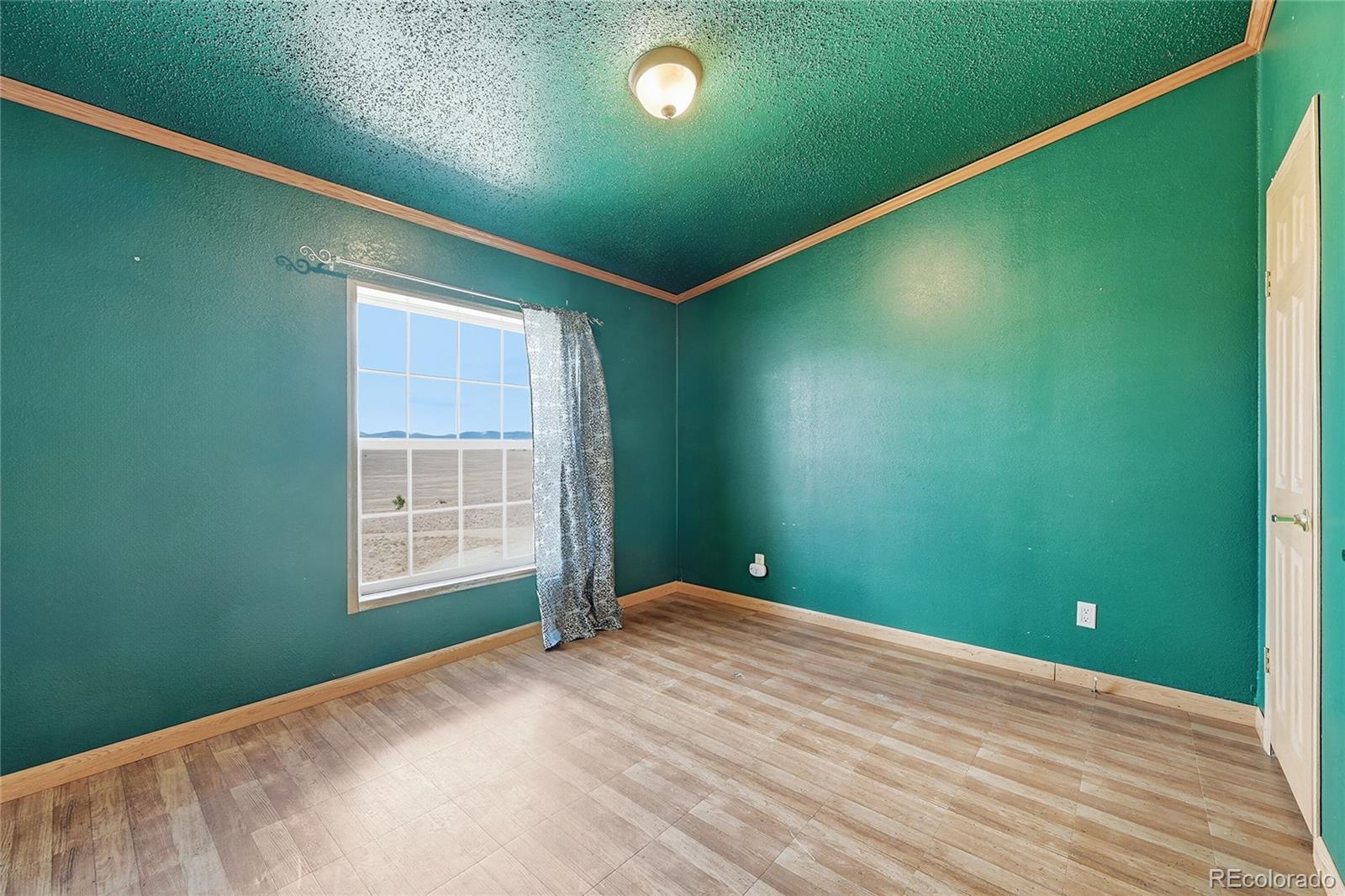 4441 Goldenburg Canyon Road Hartsel, CO 80449 - Photo 25 of 48 a view of a big room with windows and entryway
