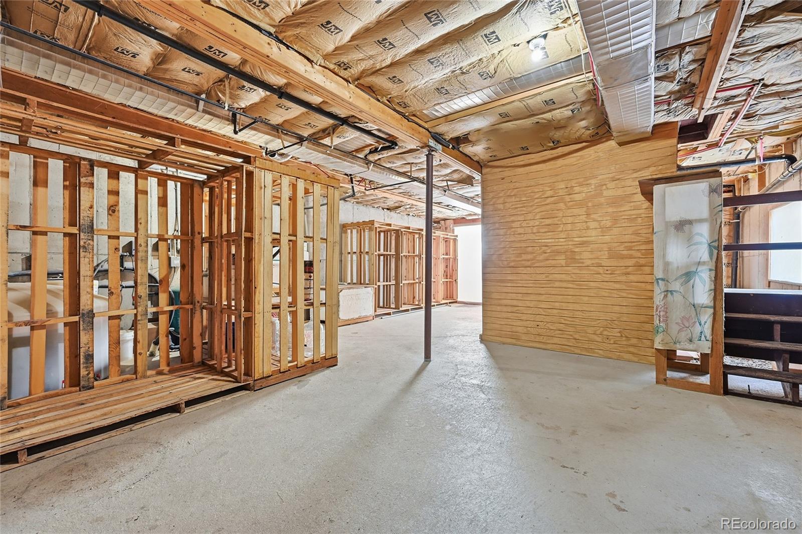 4441 Goldenburg Canyon Road Hartsel, CO 80449 - Photo 31 of 48 a view of a hallway with wooden walls