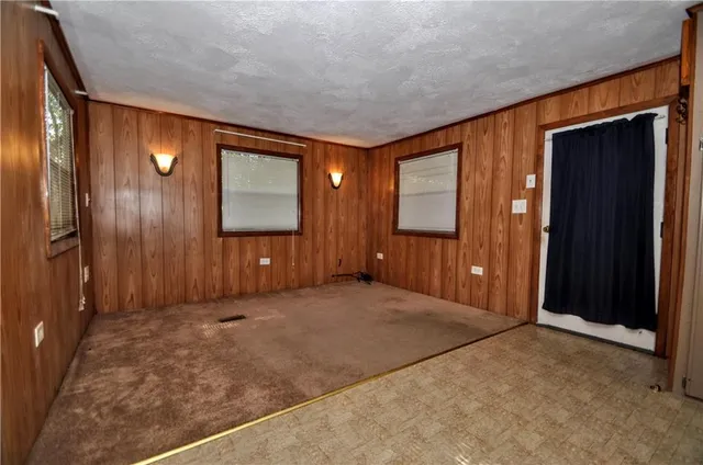an empty room with windows and closet