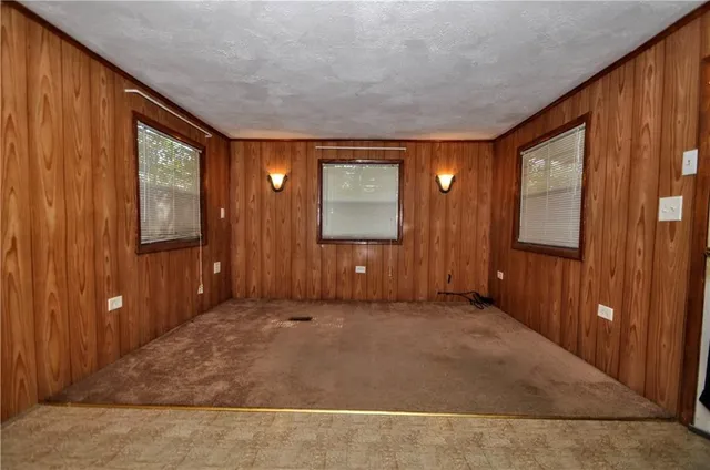 an empty room with windows and closet