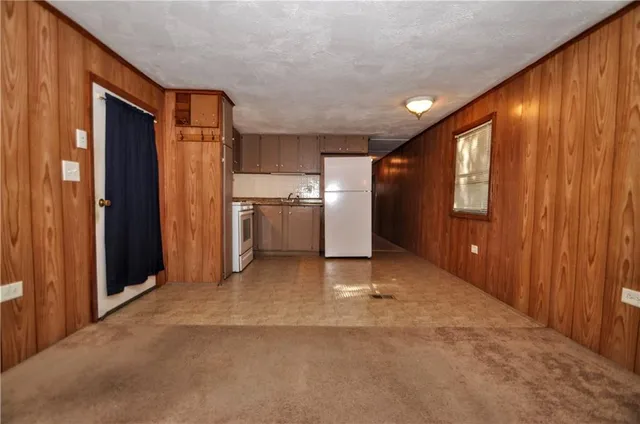 a view of a hallway with a refrigerator