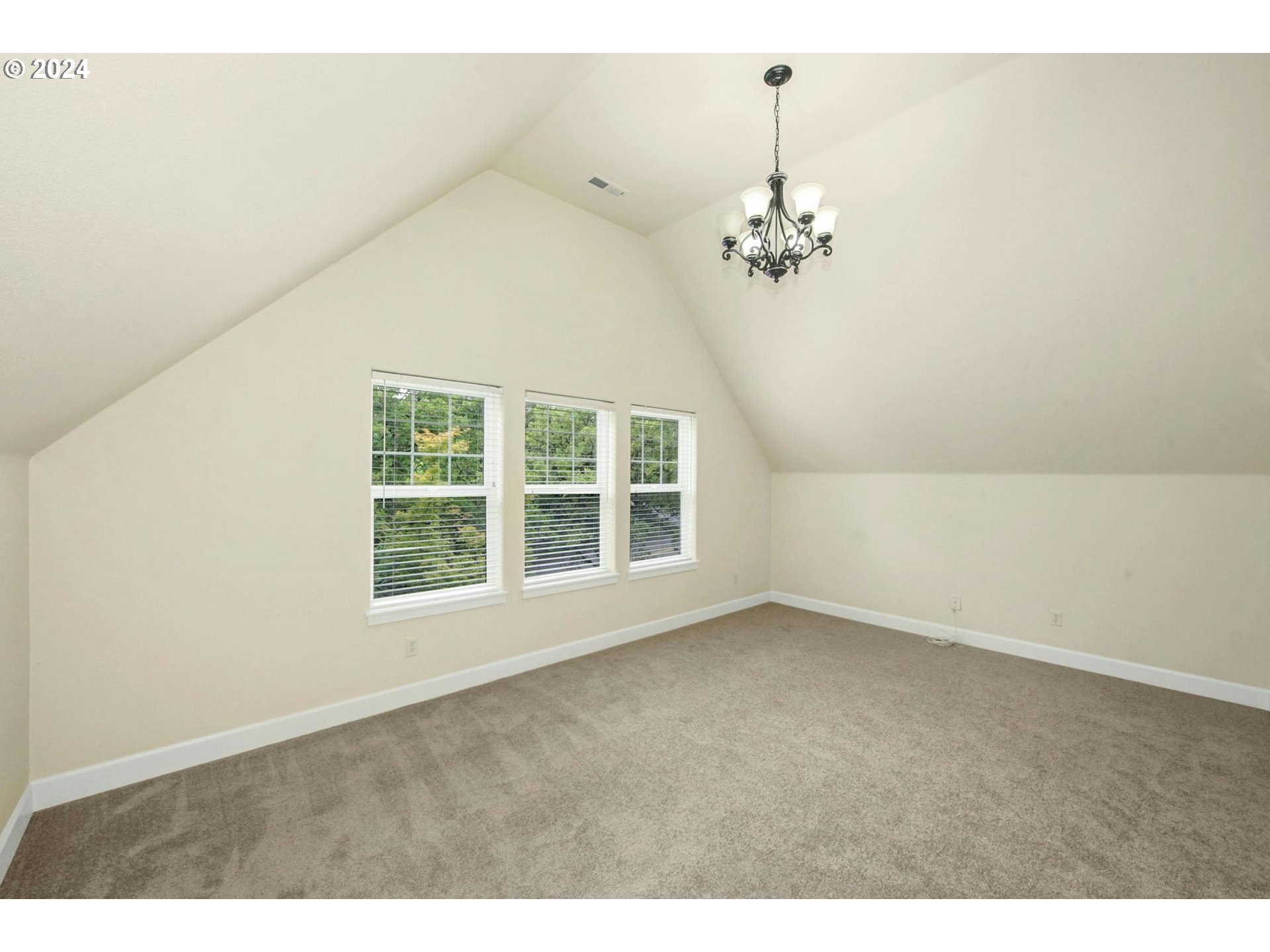 2324 Northwest Miller Road Portland, OR 97229 - Photo 25 of 29 an empty room with windows and fan