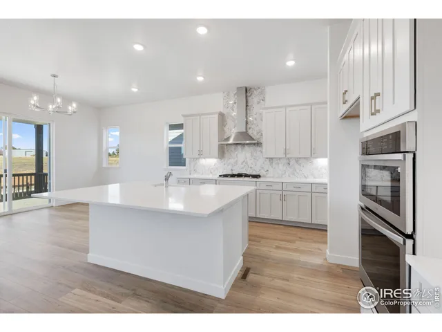 a large kitchen with cabinets and stainless steel appliances