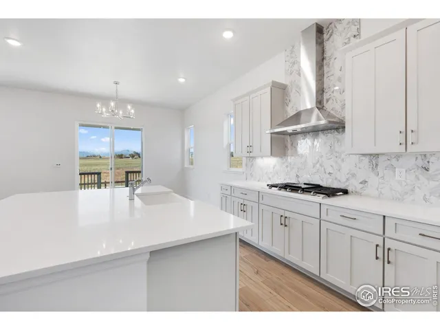 a kitchen with stainless steel appliances a sink stove and cabinets