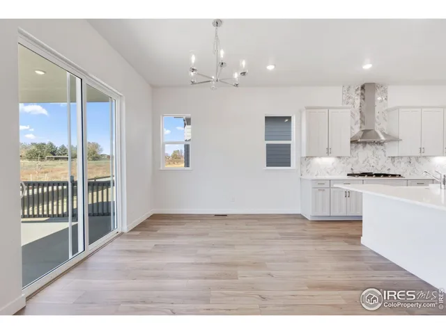 a view of kitchen with granite countertop cabinets and window
