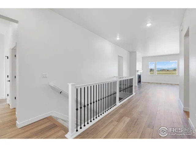 a view of hallway with wooden floor
