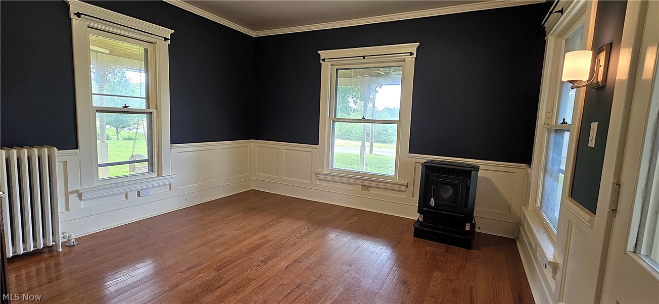 7414 Greenwich Road Seville, OH 44273 - Photo 18 of 50 Cozy Family room featuring beautiful woodwork, hardwood floors, wood burning stove, open to the wrap around porch.